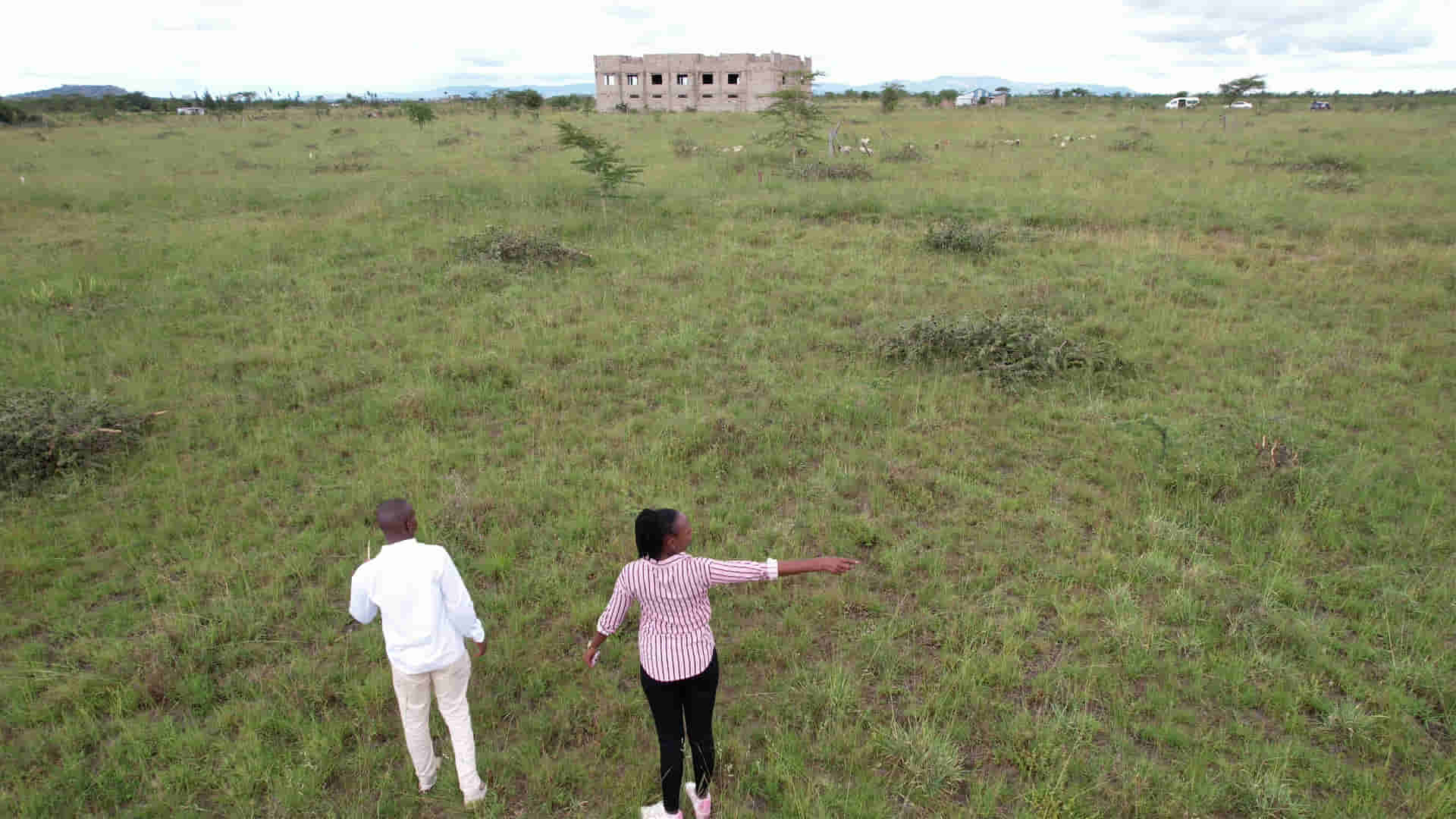 A couple choosing their plot on site.